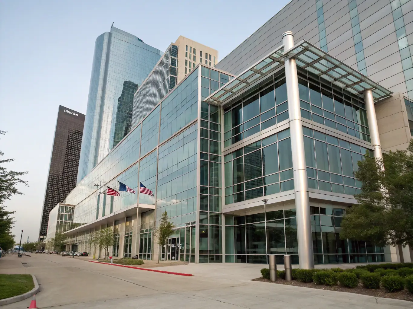 A professional image showcasing a modern office building with wind turbines in the background, representing the energy sector in Texas.